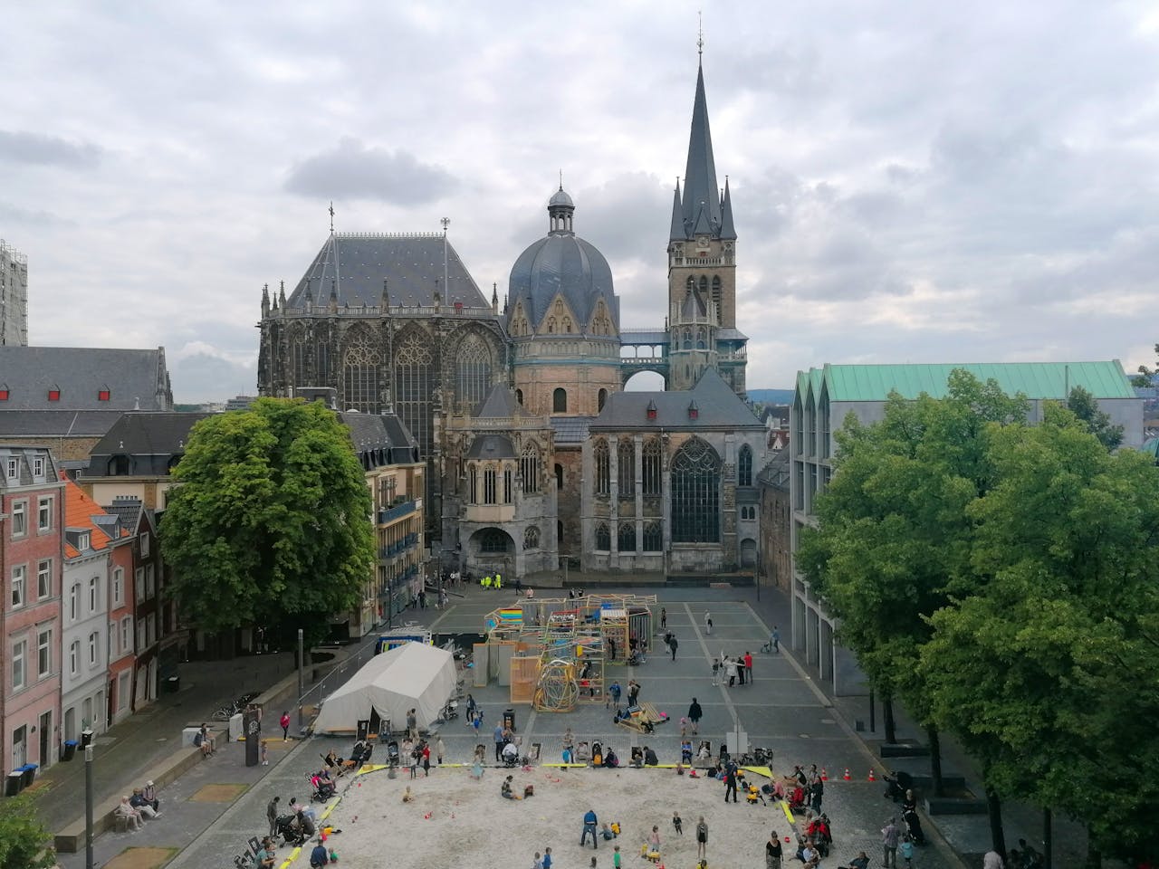 Aerial shot of Aachen Cathedral with surrounding architecture and playground.