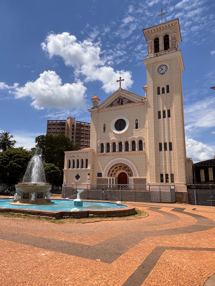Stunning view of a historic church with a fountain under a clear sky in Aracatuba, Brazil.